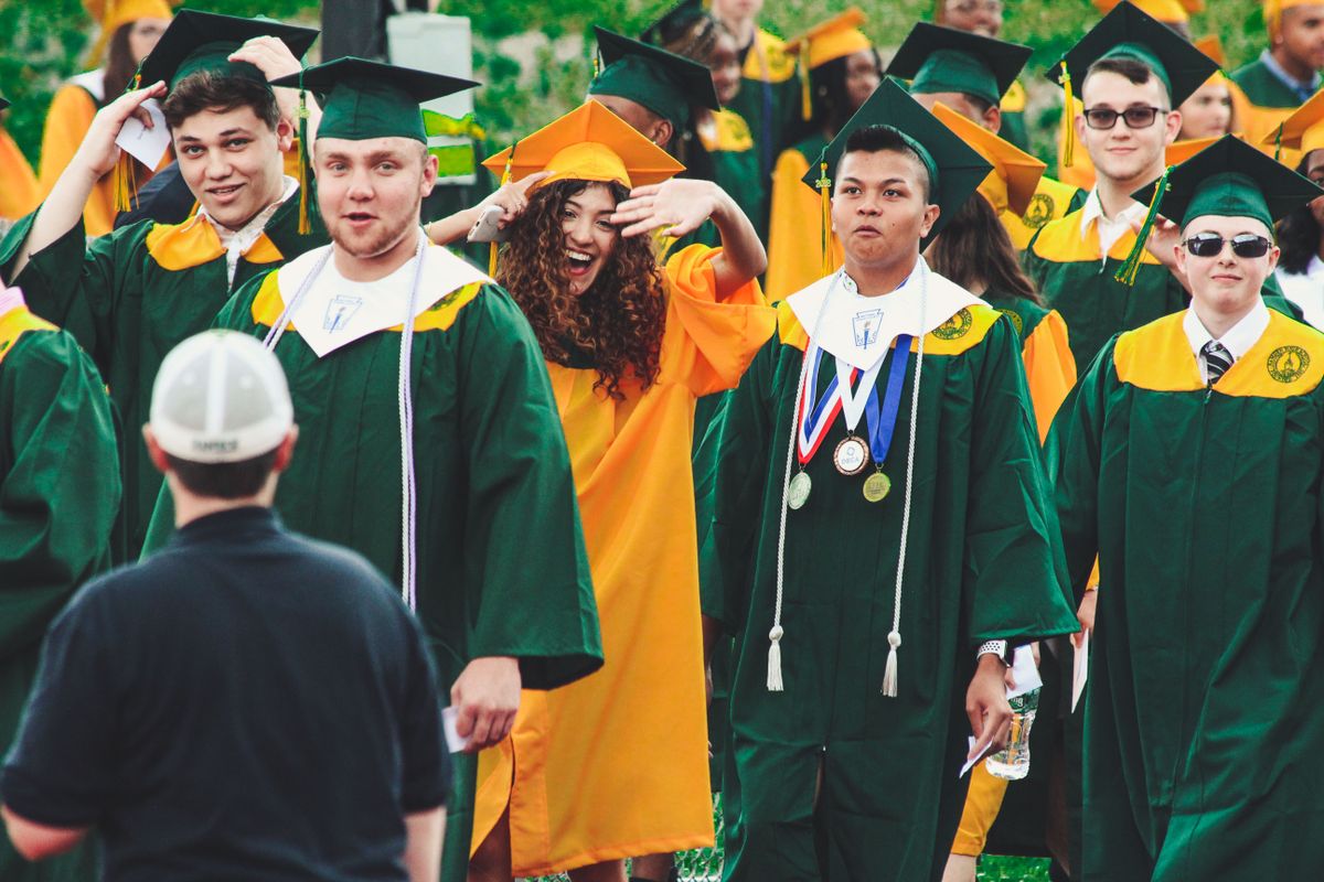 Group of graduates walking together in caps and gowns